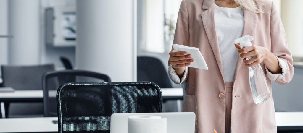 Return to work, workplace hygiene and new normal. Blond woman in business suit in protective mask